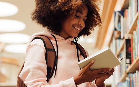 Student reading in library